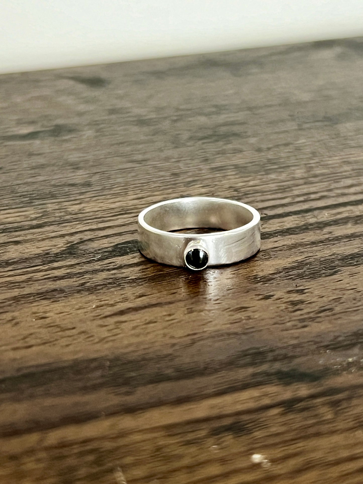 Thick hammered silver band ring with small gemstone