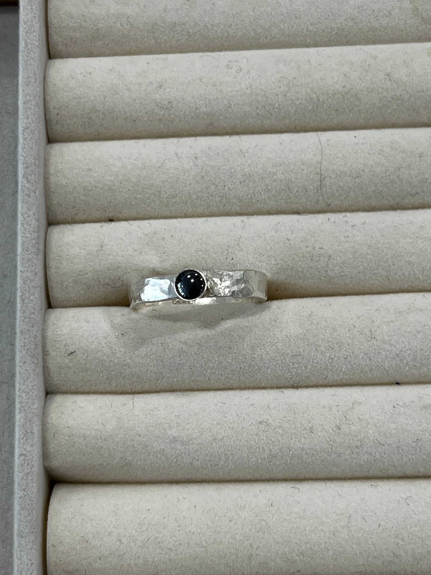 Thick hammered silver band ring with small gemstone