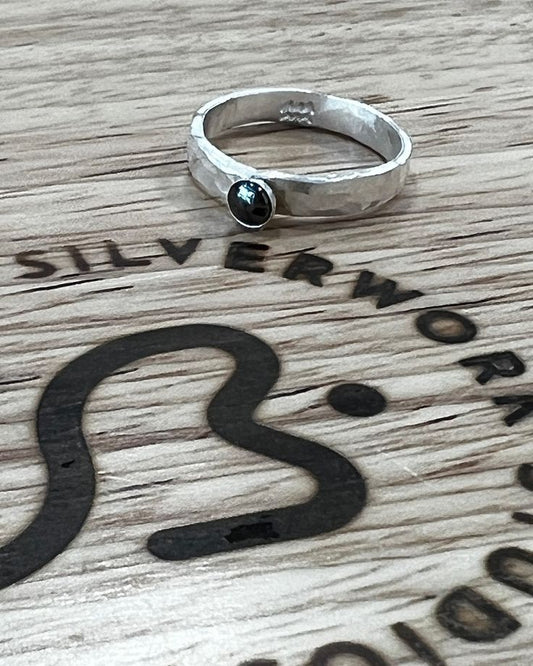 Thick hammered silver band ring with small gemstone