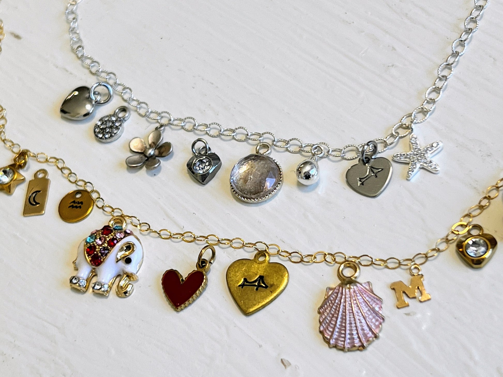 Collection of various charm bracelets on a light background